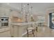 Modern kitchen with stainless steel appliances, pendant lighting, and a breakfast bar seating two at 13334 Pacchio St, Venice, FL 34293