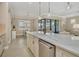 Modern kitchen with stainless steel appliances, a large island, and an adjacent dining area at 13334 Pacchio St, Venice, FL 34293