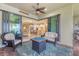 Covered patio with seating area and fire pit, overlooking a spacious interior with open kitchen and living space at 13334 Pacchio St, Venice, FL 34293