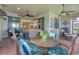 Spacious lanai featuring ample seating, a ceiling fan, and tranquil views of the lake and nearby greenery at 13334 Pacchio St, Venice, FL 34293