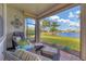 Covered patio offers seating and tranquil water views, and an outdoor grill at 13334 Pacchio St, Venice, FL 34293