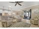 Bright open-concept living room with access to kitchen, dining area and scenic patio, filled with comfortable seating at 13334 Pacchio St, Venice, FL 34293