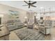 Spacious living room featuring neutral tones, tile floors, and a serene ambiance, connecting to the kitchen area at 13334 Pacchio St, Venice, FL 34293
