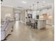 Bright open-concept living area leads into a modern kitchen with an island and bar stools at 13334 Pacchio St, Venice, FL 34293