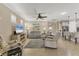 Bright open-concept living room with neutral tones, tile floors, and access to the kitchen at 13334 Pacchio St, Venice, FL 34293