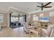 Inviting living room with a view of the outdoor patio, complete with comfortable seating and a ceiling fan at 13334 Pacchio St, Venice, FL 34293