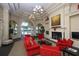 Elegant lounge area featuring comfortable seating, a fireplace, and views of the pool area at 13334 Pacchio St, Venice, FL 34293