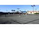 Community tennis courts with players, lighting, and lush tropical surroundings at 13334 Pacchio St, Venice, FL 34293