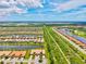 Aerial view of a residential area with multiple houses, lush greenery, and a serene lake at 13913 Alafaya St, Venice, FL 34293