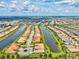 Stunning aerial view of a community surrounded by water and featuring well-maintained homes at 13913 Alafaya St, Venice, FL 34293