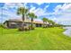 Expansive backyard with lush green lawn, mature trees, and a screened lanai perfect for outdoor living at 13913 Alafaya St, Venice, FL 34293