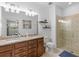 Bathroom with double sinks and a glass shower at 13913 Alafaya St, Venice, FL 34293
