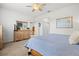 Bedroom boasts natural light, ceiling fan, and furniture at 13913 Alafaya St, Venice, FL 34293