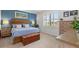 Bedroom with blue accent wall, natural light and wood furniture at 13913 Alafaya St, Venice, FL 34293