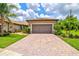 Charming single Gathering home featuring a brick driveway and meticulous landscaping at 13913 Alafaya St, Venice, FL 34293