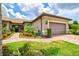 Beautiful home with a brick walkway and a well-manicured lawn and colorful landscaping at 13913 Alafaya St, Venice, FL 34293
