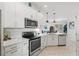 Modern kitchen features white cabinets, stainless steel appliances, and quartz countertops at 13913 Alafaya St, Venice, FL 34293