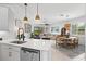 Bright open concept kitchen with stainless appliances and view of dining and living areas at 13913 Alafaya St, Venice, FL 34293