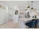 Bright kitchen with quartz countertop island and stylish barstool seating at 13913 Alafaya St, Venice, FL 34293