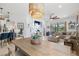 Bright living room features an oversized dining table and an oversized white flower arrangement at 13913 Alafaya St, Venice, FL 34293