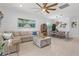 Open-concept living room with comfortable seating and dining area with stylish light fixture at 13913 Alafaya St, Venice, FL 34293
