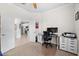 Office space features a desk, chair and storage drawers, with entry view to kitchen in background at 13913 Alafaya St, Venice, FL 34293