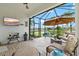 Relaxing screened patio showcases seating area with pond views and sunshade at 13913 Alafaya St, Venice, FL 34293