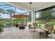 Screened patio features ample seating with views of pond and manicured green space at 13913 Alafaya St, Venice, FL 34293