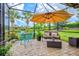 This screened-in patio has comfortable seating with pond views and sunshade at 13913 Alafaya St, Venice, FL 34293