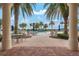 Resort-style pool area framed by palm trees and elegant columns for a luxurious experience at 13913 Alafaya St, Venice, FL 34293