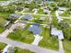 Overhead shot of a home with a private screened pool, set in a serene, tree-lined residential area at 1536 Porpoise Rd, Venice, FL 34293