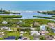 Overhead shot of a waterfront community, showcasing houses with lush landscaping and access to scenic water views at 1536 Porpoise Rd, Venice, FL 34293