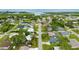 Community aerial view showcasing homes with pools and lush green foliage at 1536 Porpoise Rd, Venice, FL 34293