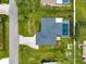 Aerial view of home with dark roof, screened-in pool, driveway, and landscaped surroundings at 1536 Porpoise Rd, Venice, FL 34293