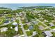 Aerial view of a residential neighborhood, featuring charming homes, green lawns, and close proximity to the serene waterfront at 1536 Porpoise Rd, Venice, FL 34293