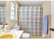 The bathroom features a shower/tub combo, a window, and a yellow sink at 1536 Porpoise Rd, Venice, FL 34293