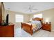 Cozy bedroom featuring a ceiling fan, natural lighting, and traditional furniture at 1536 Porpoise Rd, Venice, FL 34293