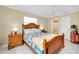 Comfortable bedroom with neutral walls, tile floors, and classic wooden furniture at 1536 Porpoise Rd, Venice, FL 34293