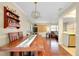 Bright dining room featuring a wooden table, bench, and view into the living room at 1536 Porpoise Rd, Venice, FL 34293