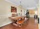 Dining room featuring a large wooden table, bench and chandelier at 1536 Porpoise Rd, Venice, FL 34293