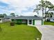 Picture of a beautiful single-story home with a large, green lawn and an attached two-car garage at 1536 Porpoise Rd, Venice, FL 34293