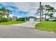 Single-story home with well-kept lawn, paved driveway, and lush green exterior for a comfortable feel at 1536 Porpoise Rd, Venice, FL 34293