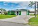 Inviting home exterior showcasing a green lawn, driveway, and attached garage at 1536 Porpoise Rd, Venice, FL 34293