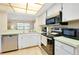 Practical kitchen featuring stainless steel appliances, white cabinets, and a functional design at 1536 Porpoise Rd, Venice, FL 34293