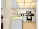 The kitchen features stainless appliances and bar seating at 1536 Porpoise Rd, Venice, FL 34293