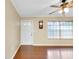 Bright living room featuring hardwood floors, a ceiling fan, and a front door at 1536 Porpoise Rd, Venice, FL 34293