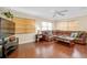 Inviting living room with hardwood floors, a ceiling fan, and ample natural light from large windows at 1536 Porpoise Rd, Venice, FL 34293
