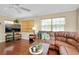 Relaxing living room featuring hardwood floors, a plush sofa, and natural light at 1536 Porpoise Rd, Venice, FL 34293