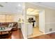 Living room with wood floors that opens into a kitchen with bar seating at 1536 Porpoise Rd, Venice, FL 34293