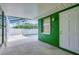 The pool area features a screened enclosure, a green wall, and a white door at 1536 Porpoise Rd, Venice, FL 34293